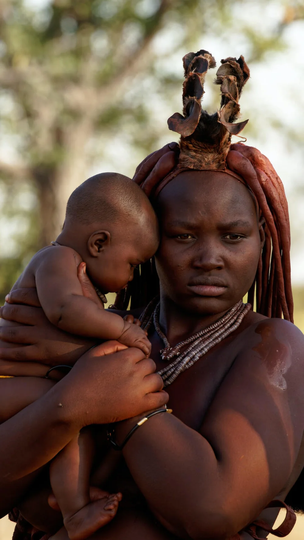 A Himba mother and child in traditional red ochre